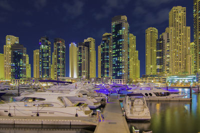 Skyscrapers in city against cloudy sky