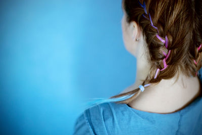 Generation z girl hairstyle on blue background. colorful hair