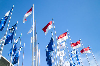 Low angle view of flag flags against sky