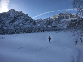 Rear view of woman walking on snow