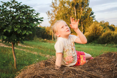 Child on haystack.