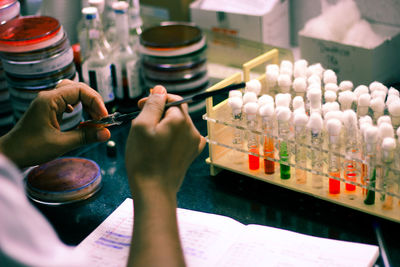 Close-up of person hands experimenting in laboratory