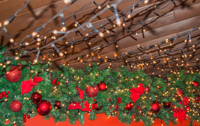 Festive background decorations, garlands of light bulbs on the dark wooden ceiling of the interior. 