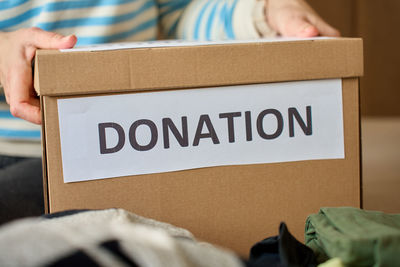 Midsection of woman holding box