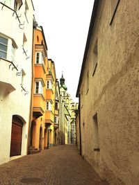 Narrow alley amidst buildings against sky