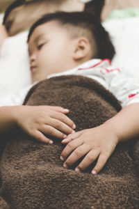 High angle view of boy lying on bed