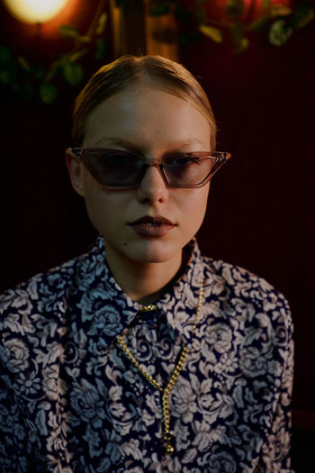 Close-up portrait of beautiful young woman wearing sunglasses