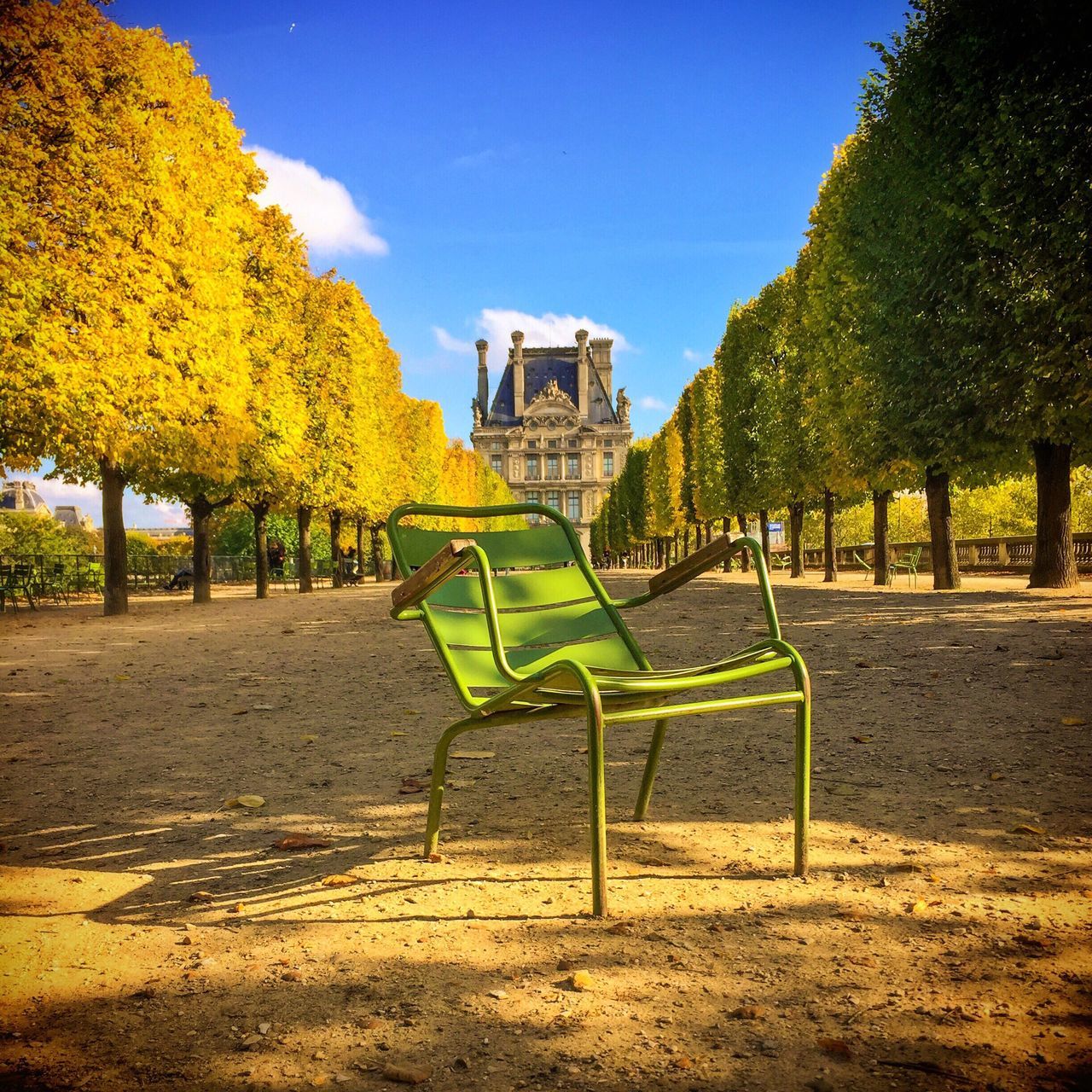 tree, park - man made space, bench, empty, building exterior, green color, tranquility, footpath, clear sky, tranquil scene, park, travel destinations, outdoors, day, sky, grassland, outdoor play equipment, nature, scenics, beauty in nature, remote