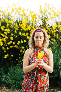 Portrait of beautiful woman standing on field