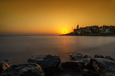 Scenic view of sea against orange sky