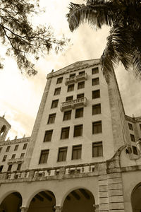 Low angle view of building against cloudy sky