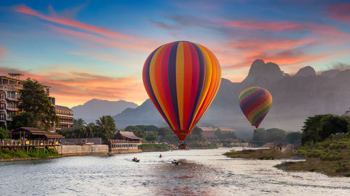 Nam song river at sunset with hot air balloon in vang vieng, laos, beautiful vang vieng, laos.