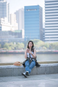Portrait of young woman sitting outdoors