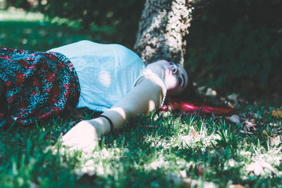 Low section of woman lying on grass