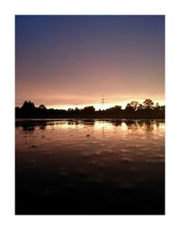 Scenic view of calm lake at sunset