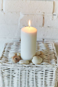 Close-up of lit candles on table at home