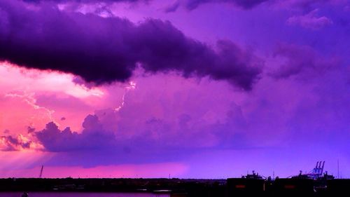 Dramatic sky over silhouette landscape