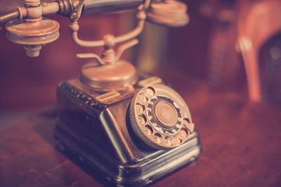 Close-up of old telephone on table