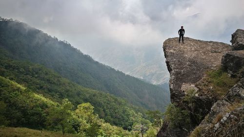 Man standing on mountains against sky