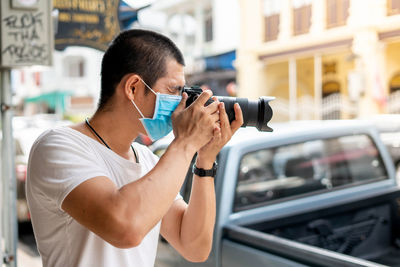 Side view of man photographing