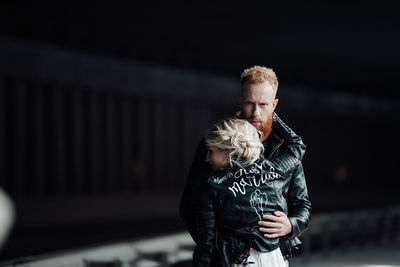 Man and woman standing against blurred background