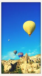 Low angle view of balloons against blue sky