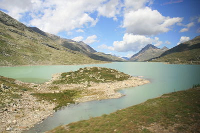 Scenic view of lake and mountains against sky