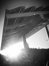 Crowd of people on bridge against sky