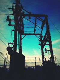 Low angle view of power lines against blue sky