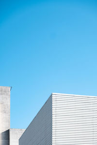 Low angle view of building against clear blue sky