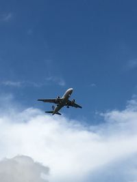 Low angle view of airplane flying in sky