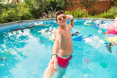 Full length of shirtless boy in swimming pool