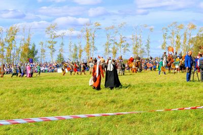 People on field against sky