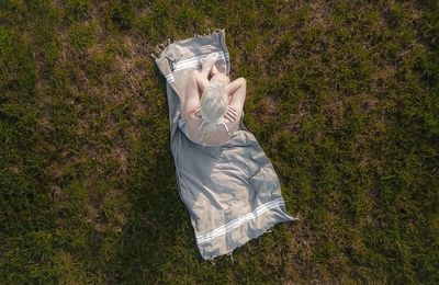 High angle view of woman holding umbrella on field