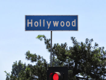 Low angle view of road sign against sky