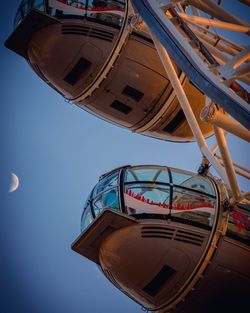 Low angle view of millennium wheel against blue sky at dusk