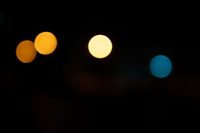 Defocused lights against sky at night