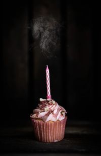 Close-up of cupcakes against black background