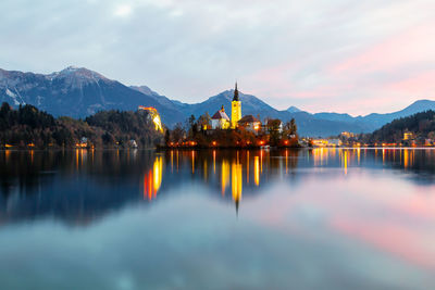 Scenic view of lake by mountains against sky