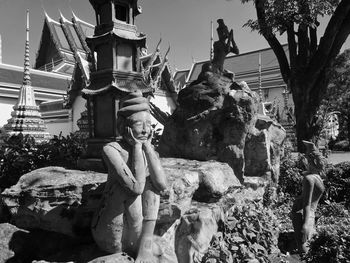 Low angle view of statue against trees
