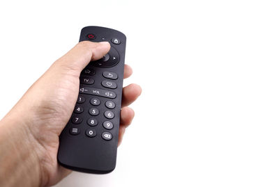 Midsection of man holding smart phone against white background