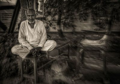 Portrait of man sitting on seat