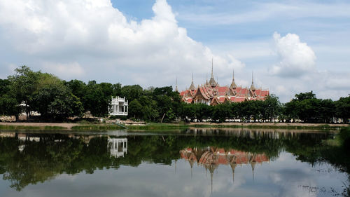 Scenic view of lake by building against sky