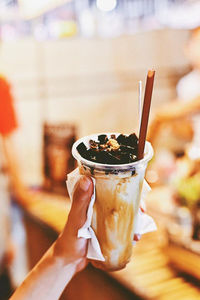 Close-up of hand holding ice cream