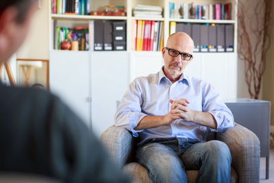 Full length of man sitting in office