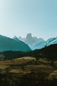 Scenic view of snowcapped mountains against clear sky