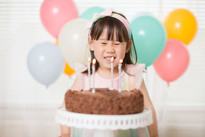 Young girl blowing candles for celebreating her 4th years birthday