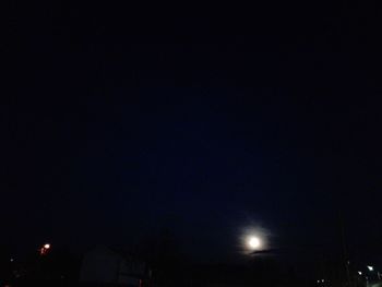 Low angle view of illuminated street light against sky at night