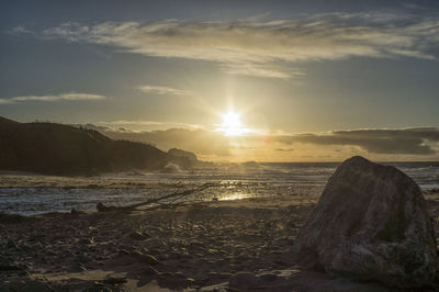 Scenic view of beach against sky during sunset