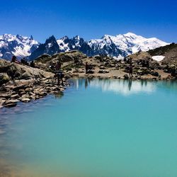 Scenic view of snowcapped mountains against blue sky